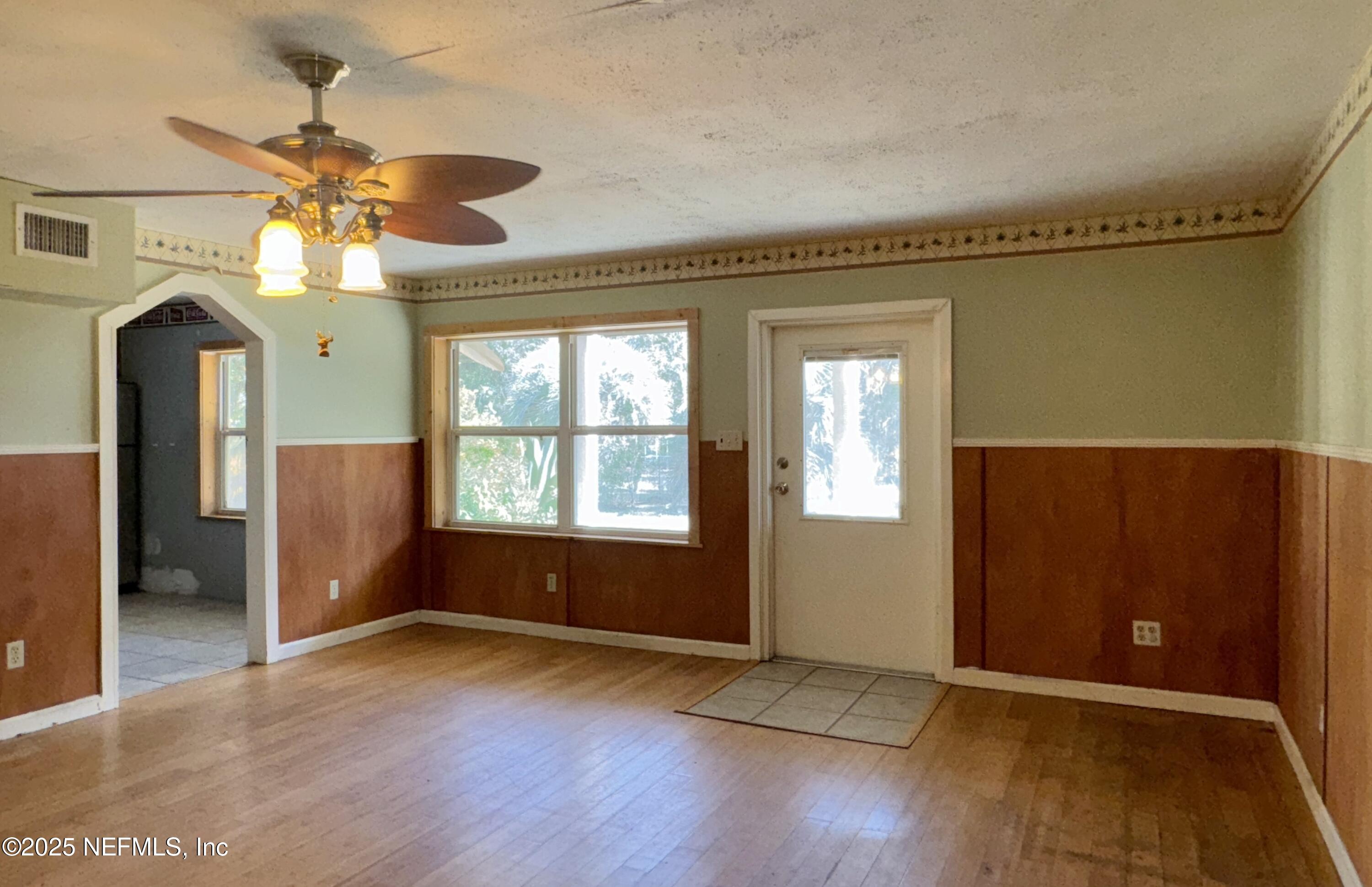 5756 Southeast 55th Terrace Keystone Heights, FL 32656 - Photo 7 of 35 wooden floor in an empty room with a window
