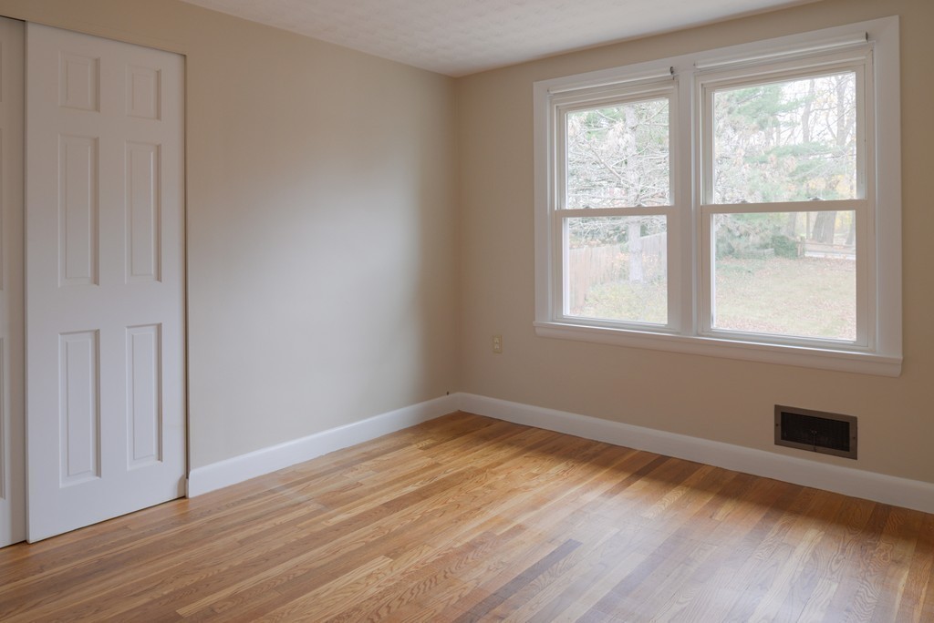 8 Puritan Road Marblehead, MA 01945 - Photo 17 of 25 an empty room with wooden floor and windows
