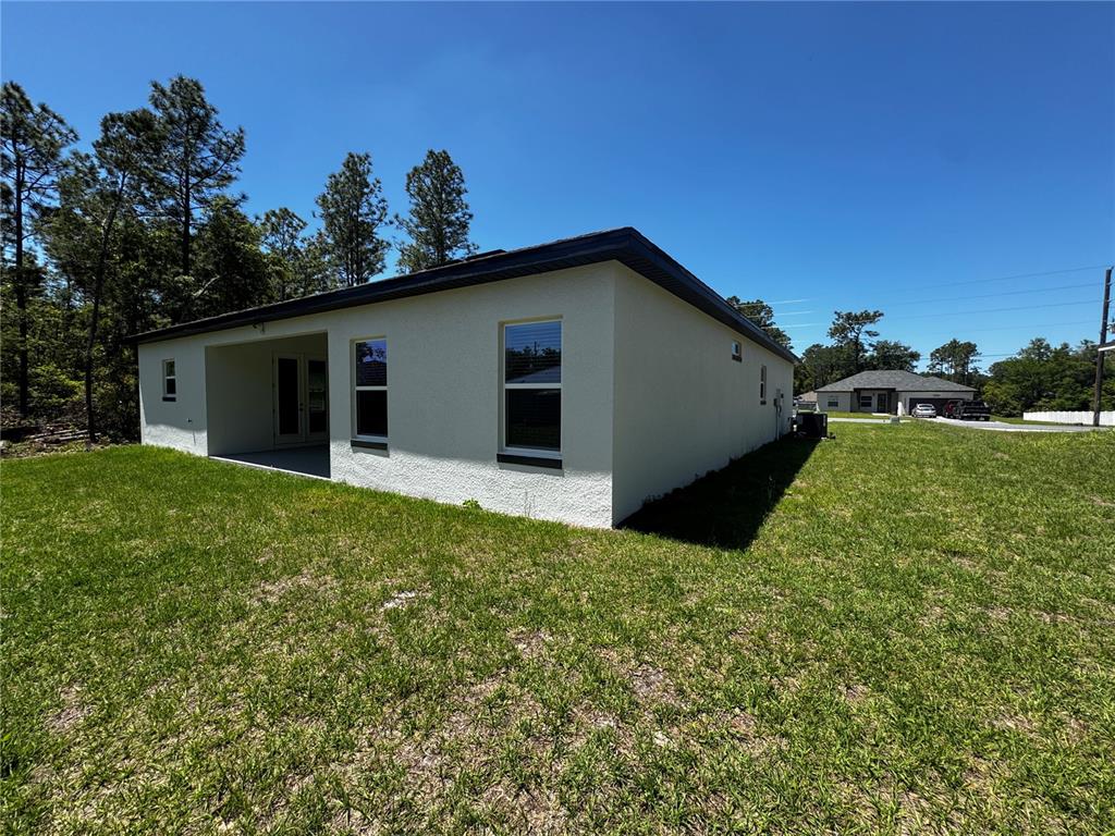 13101 Southwest 72nd Terrace Road Ocala, FL 34473 - Photo 17 of 18 a view of an house with backyard space and garden