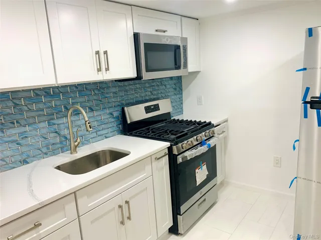 a kitchen with granite countertop a stove and a sink