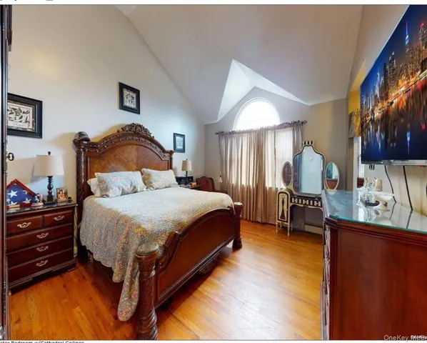 a bedroom with a bed a mirror and lamp