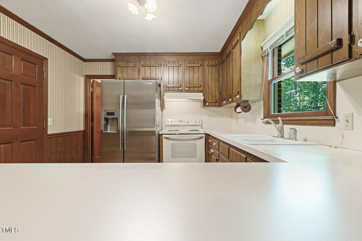 6013 Splitrock Trail Apex, NC 27539 - Photo 17 of 53 a kitchen with stainless steel appliances a sink and a refrigerator