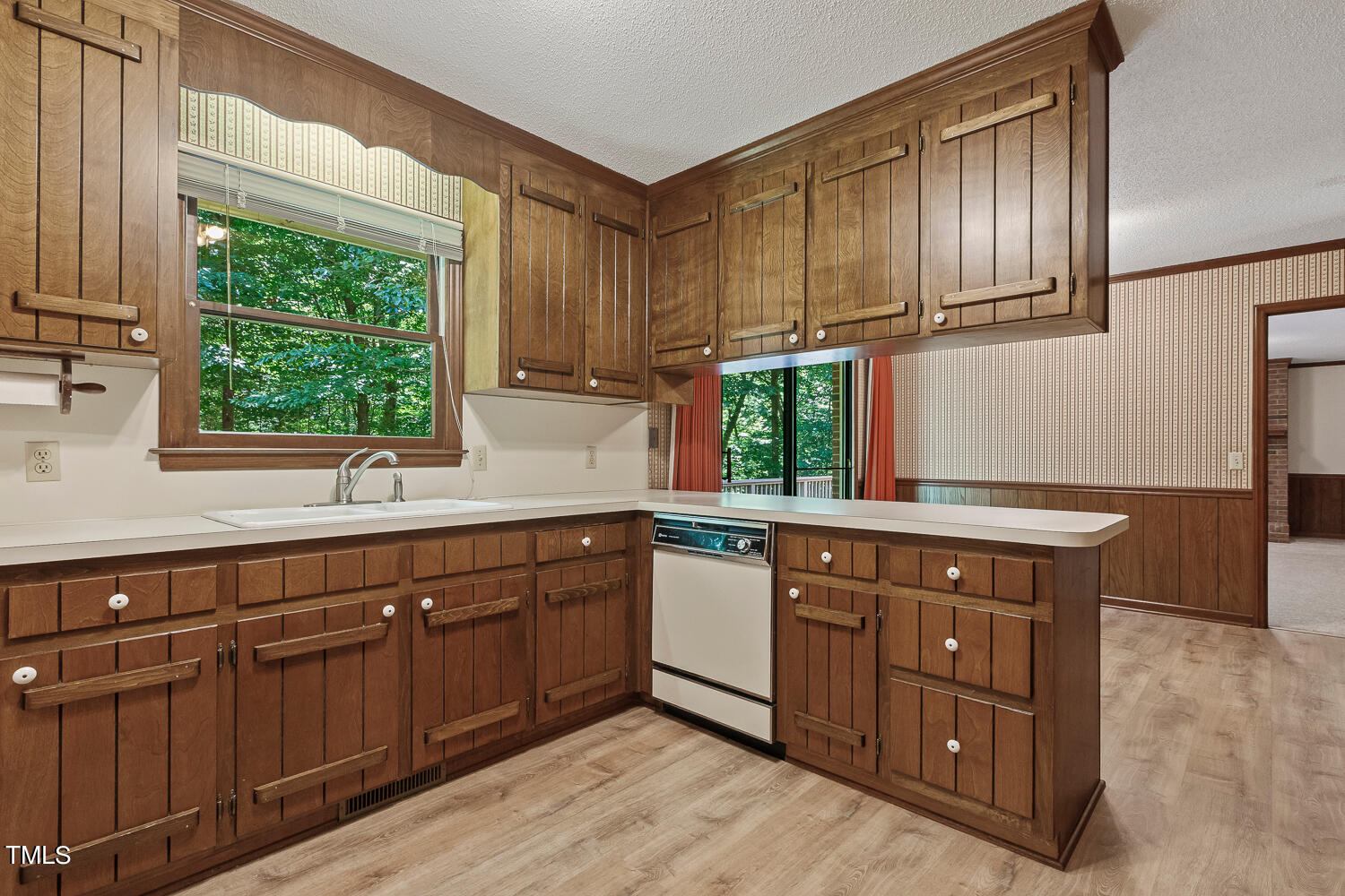 6013 Splitrock Trail Apex, NC 27539 - Photo 18 of 53 a kitchen with stainless steel appliances granite countertop wooden cabinets a sink and dishwasher with wooden floor