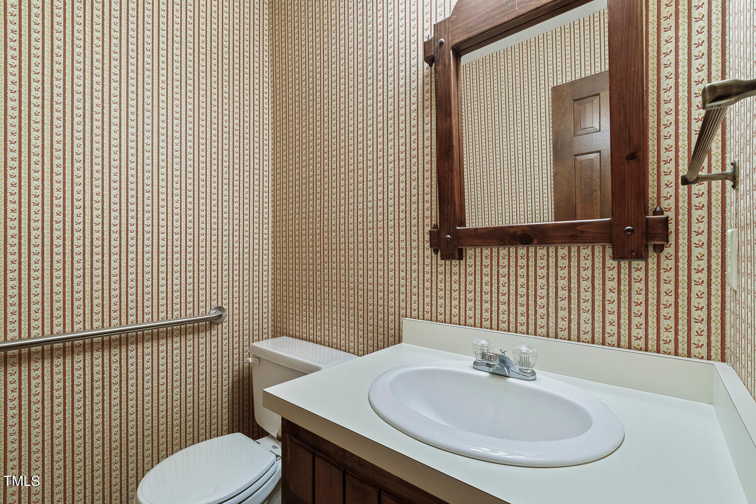 6013 Splitrock Trail Apex, NC 27539 - Photo 28 of 53 a bathroom with a sink a toilet and mirror