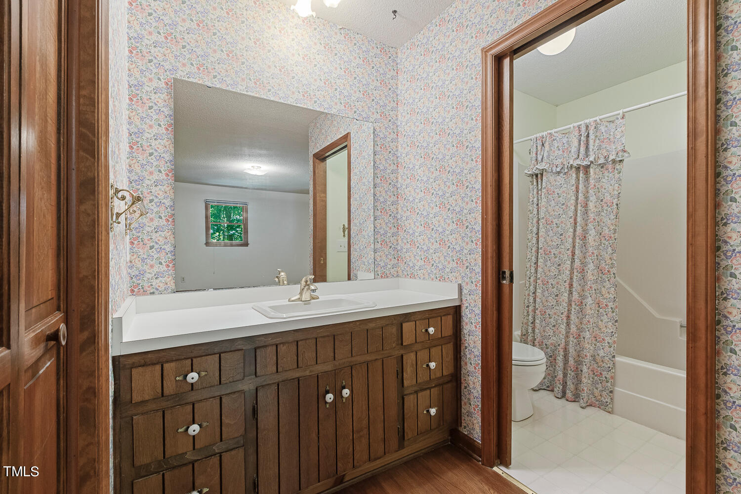 6013 Splitrock Trail Apex, NC 27539 - Photo 33 of 53 a bathroom with a double vanity sink and mirror with shower