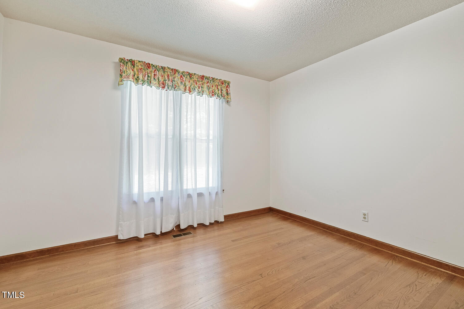 6013 Splitrock Trail Apex, NC 27539 - Photo 36 of 53 an empty room with wooden floor and windows