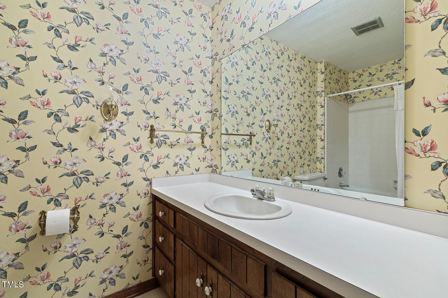 6013 Splitrock Trail Apex, NC 27539 - Photo 37 of 53 a bathroom with a sink and a mirror