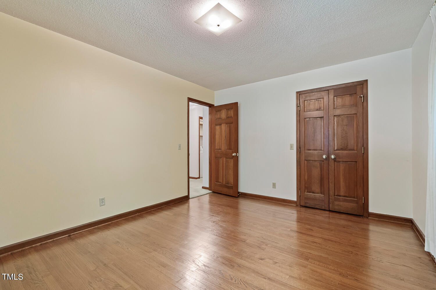 6013 Splitrock Trail Apex, NC 27539 - Photo 39 of 53 a view of an empty room with wooden floor and closet