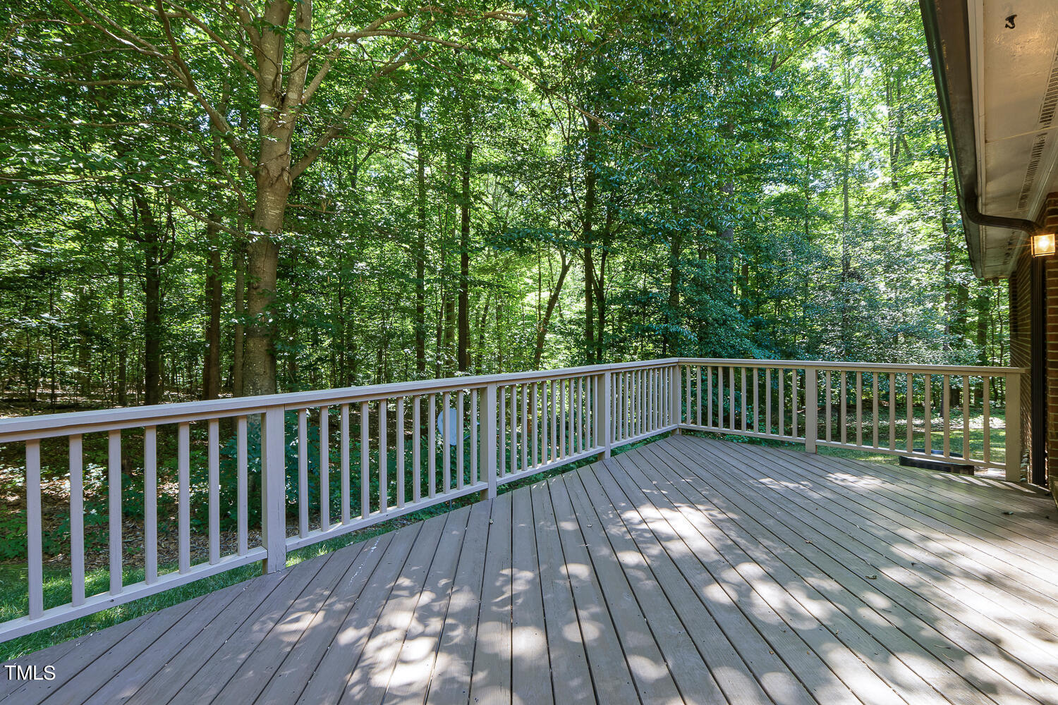 6013 Splitrock Trail Apex, NC 27539 - Photo 43 of 53 a balcony with wooden floor and trees in the back