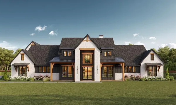 a front view of a house with a garden and yard