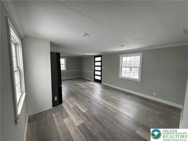 an empty room with windows and closet