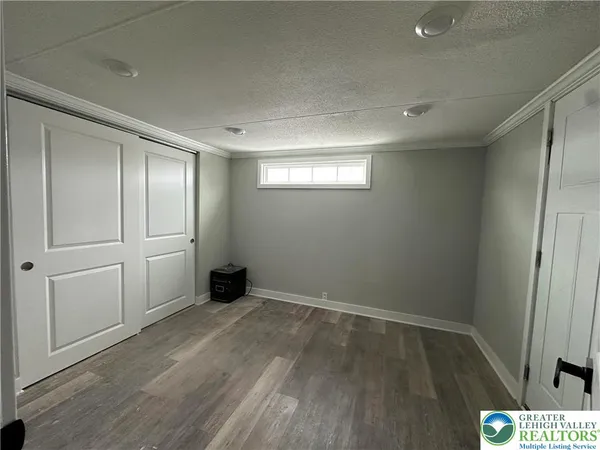 an empty room with wooden floor