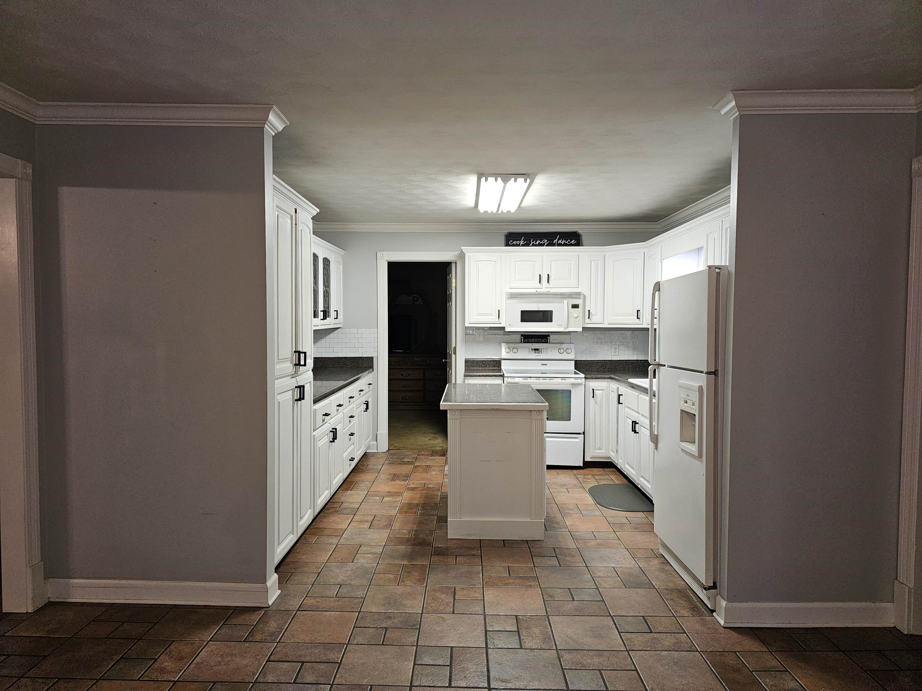 113 Smith Drive Ripley, TN 38063 - Photo 5 of 39 a large kitchen with cabinets and stainless steel appliances