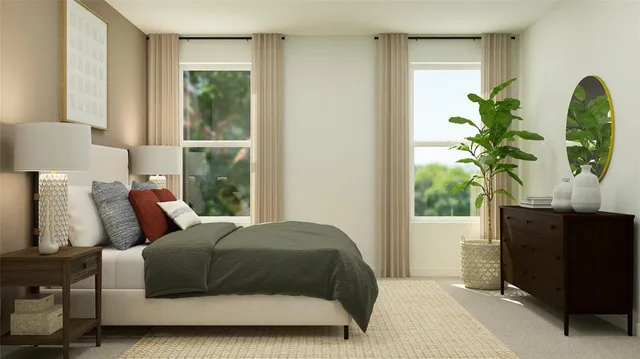 a bedroom with a bed windows and a potted plant