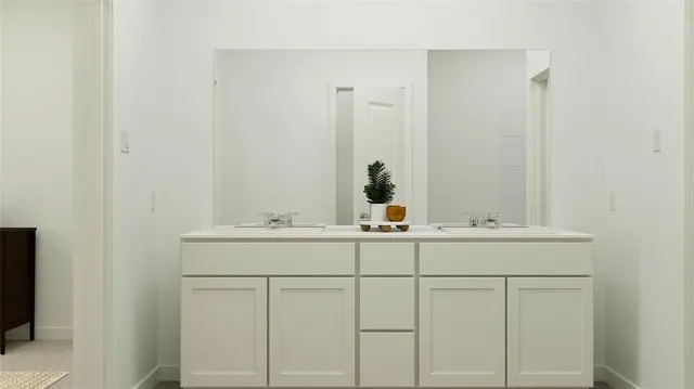 a bathroom with a sink and vanity