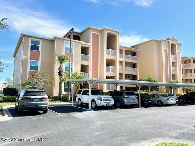 6828 Toland Drive, Unit 205 Melbourne, FL 32940 - Photo 1 of 26 a car parked in front of a building