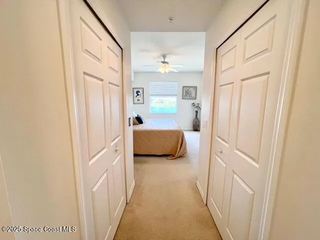 a view of a hallway with a bedroom and front door