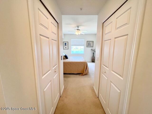 6828 Toland Drive, Unit 205 Melbourne, FL 32940 - Photo 18 of 26 a view of a hallway with a bedroom and front door