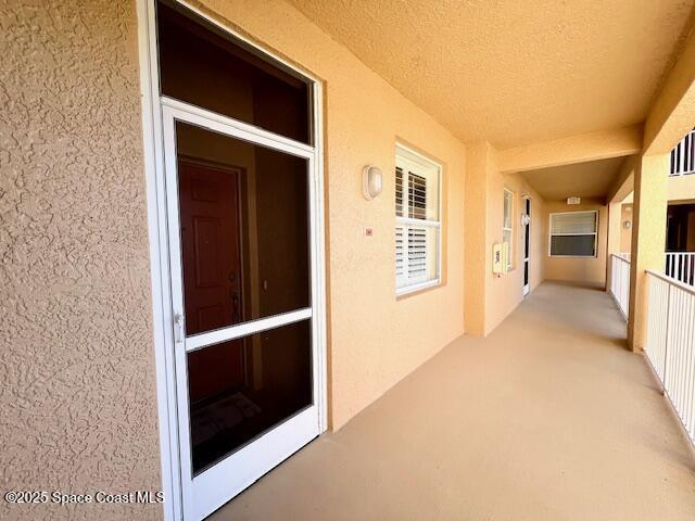 6828 Toland Drive, Unit 205 Melbourne, FL 32940 - Photo 2 of 26 a view of hallway with wooden floor and windows