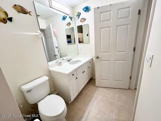 a white toilet sitting next to a bathroom sink