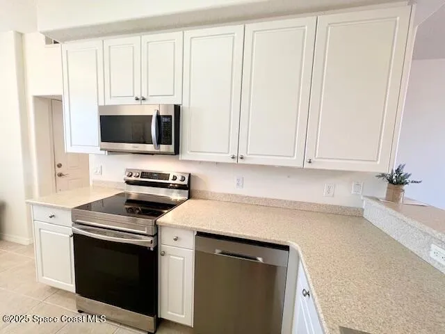 a kitchen with cabinets appliances and a sink