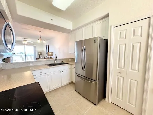 a kitchen with stainless steel appliances a refrigerator sink and cabinets
