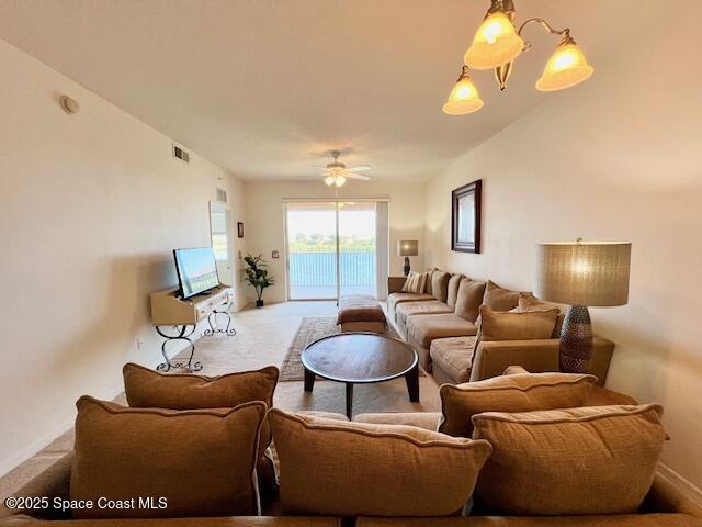 6828 Toland Drive, Unit 205 Melbourne, FL 32940 - Photo 8 of 26 a living room with furniture a lamp and a chandelier