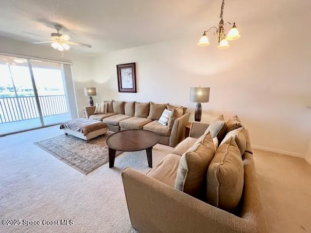 a living room with furniture ceiling fan and a rug