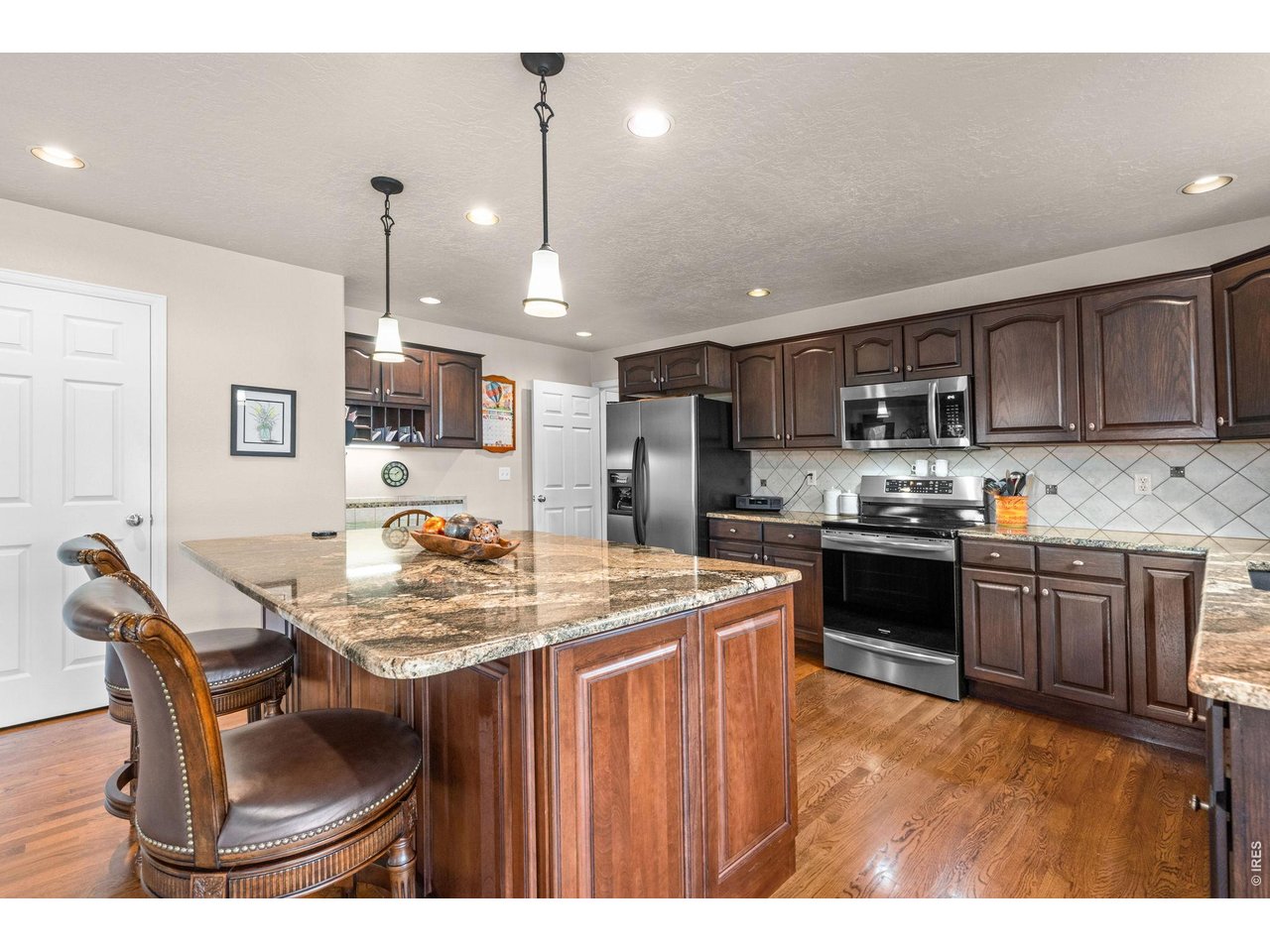 6345 Lesser Drive Greeley, CO 80634 - Photo 19 of 47 Granite countertops and pendant lighting
