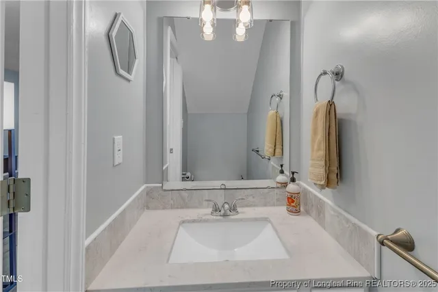 a bathroom with a tub sink and mirror