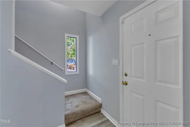 a view of an entryway with wooden floor