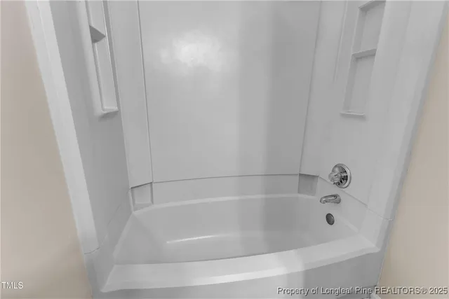 a close up of a bathtub in bathroom