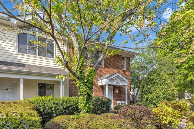 front view of a house with a tree