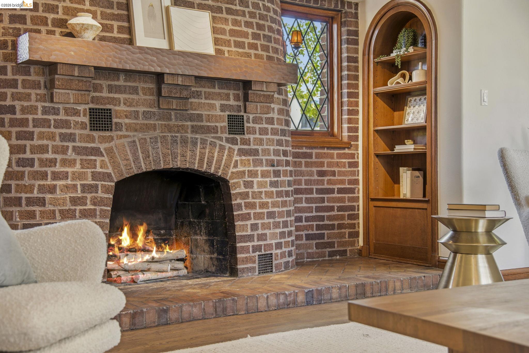 1087 Hubert Road Oakland, CA 94610 - Photo 5 of 67 Brick-clad fireplace with a substantial wood mantel and a brick hearth