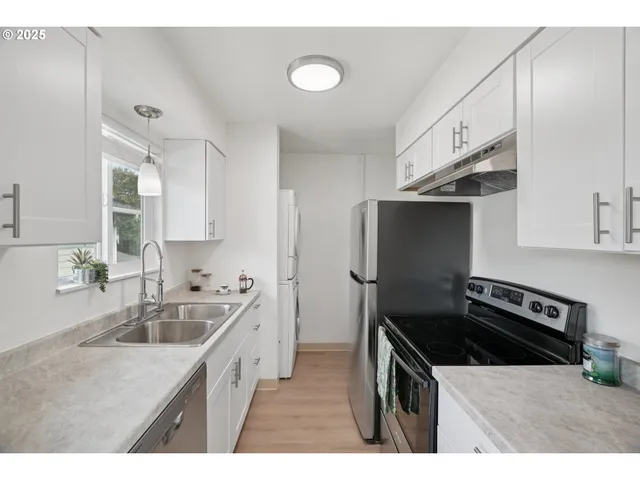 a kitchen that has a sink and a stove