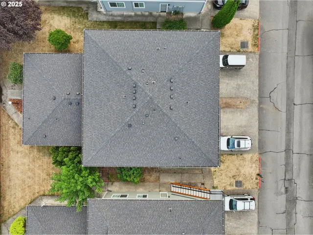 an aerial view of a house with a yard