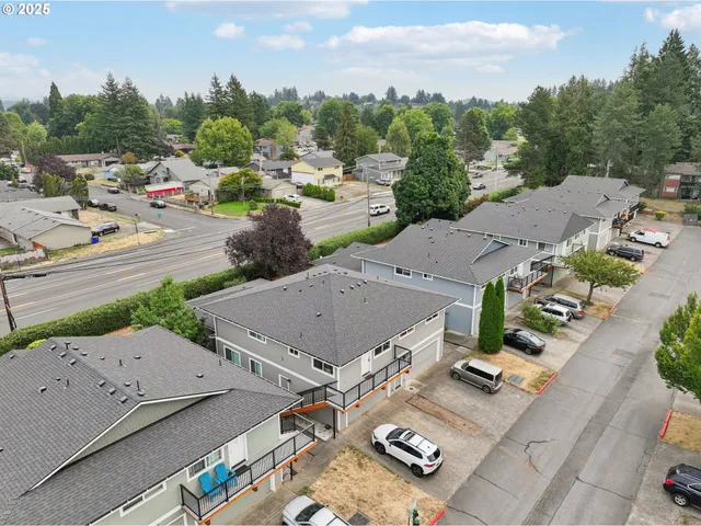 an aerial view of residential houses with outdoor space