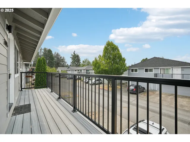 a view of balcony with wooden floor