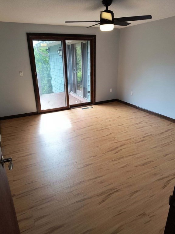 8 Birch Bluff Road Montgomery, MA 01085 - Photo 29 of 41 an empty room with wooden floor and windows