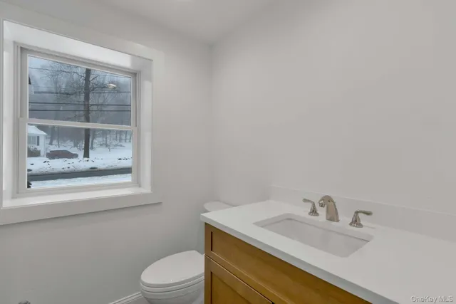 a view of a small space with wooden floor and a window