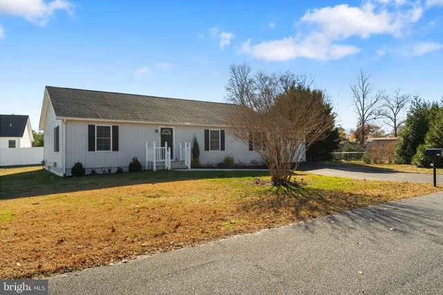 a view of a house with snow on the road