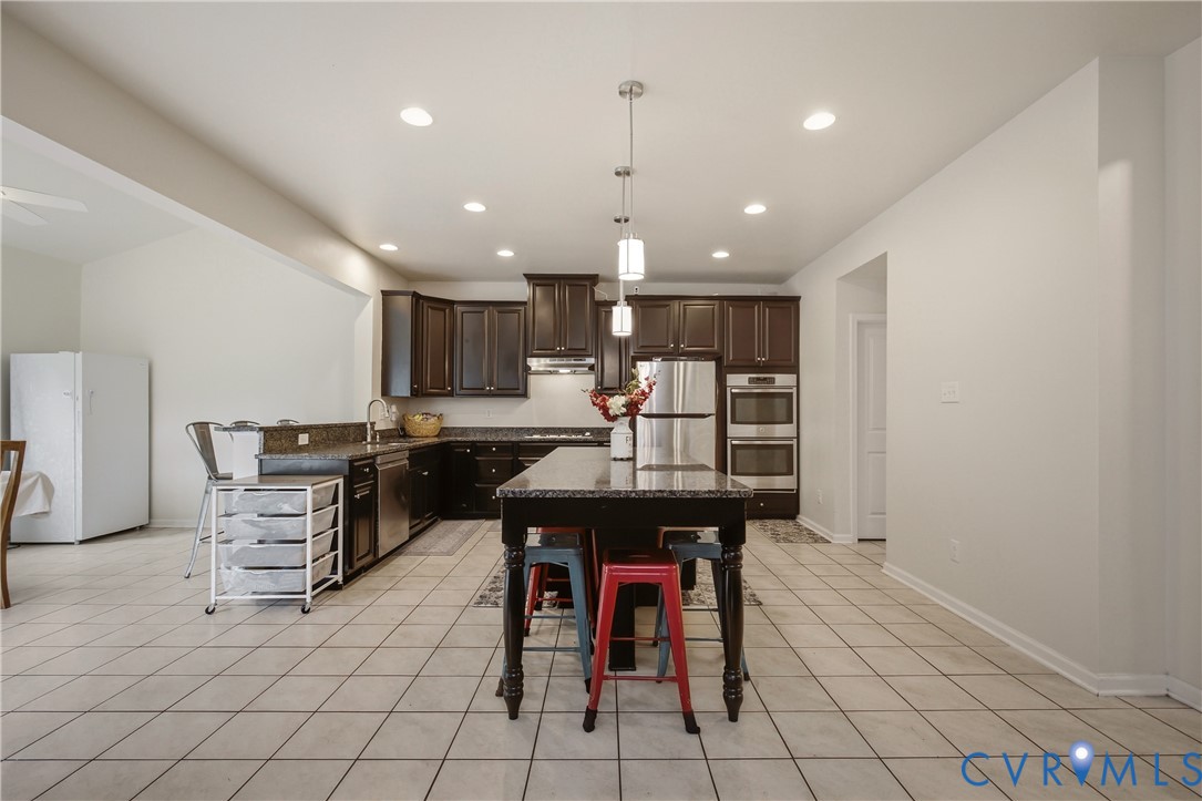 9013 Bailey Hill Road Midlothian, VA 23112 - Photo 23 of 56 Spacious kitchen featuring dark wood cabinetry, st