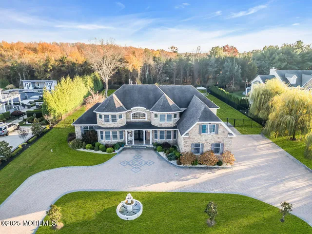 an aerial view of a house with a big yard