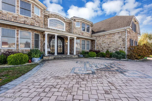 a living room with furniture a chandelier and a large window