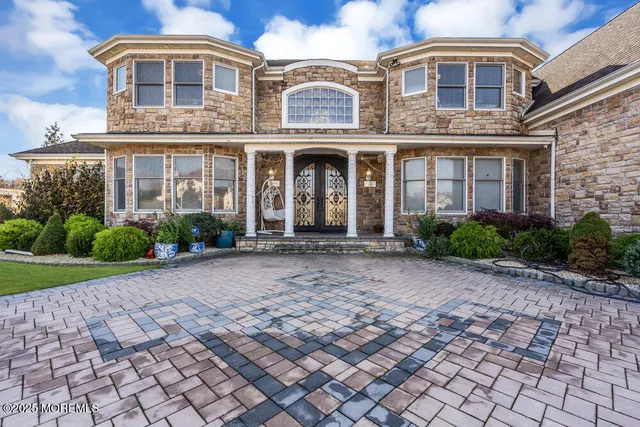 a living room with furniture and floor to ceiling windows