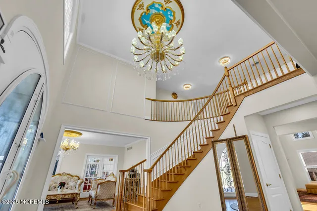 a view of a dining room with furniture wooden floor and chandelier