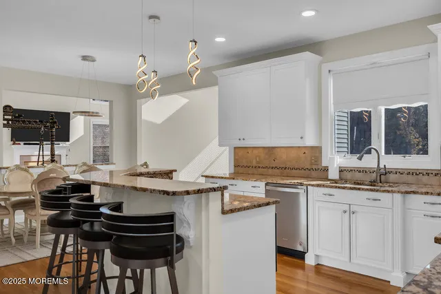 a front view of a house with garden and trees