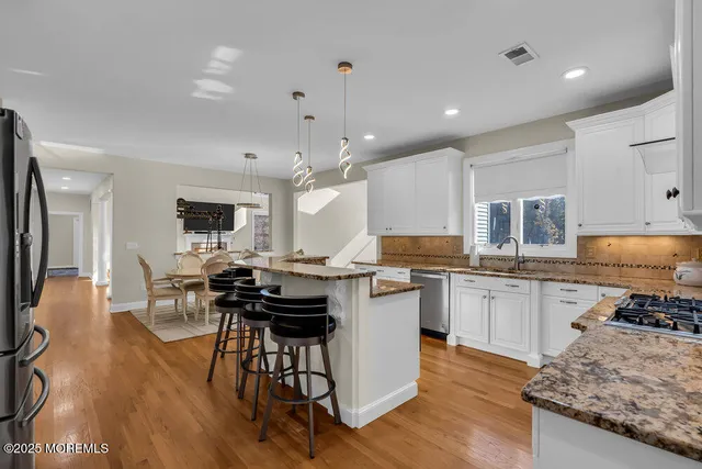 a view of a house with a big yard and large trees