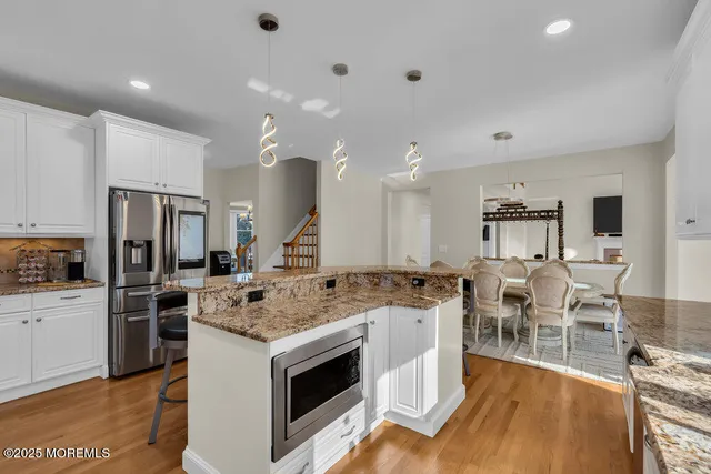 a front view of a house with garden and trees