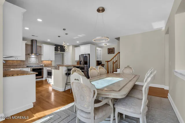 a front view of a house with a garden and trees